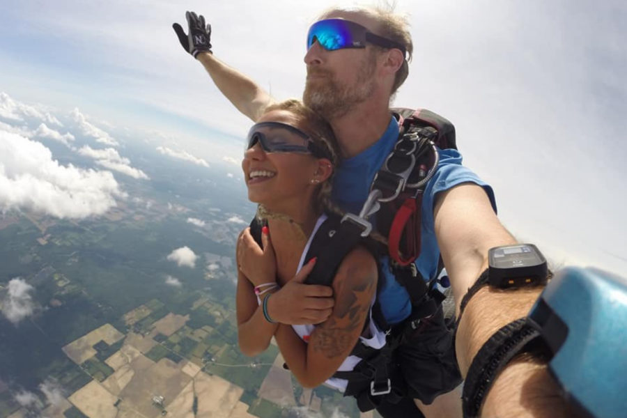 Tandem skydive with smiling girl, captured with GoPro