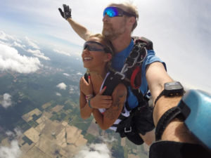 Tandem skydive with smiling girl, captured with GoPro