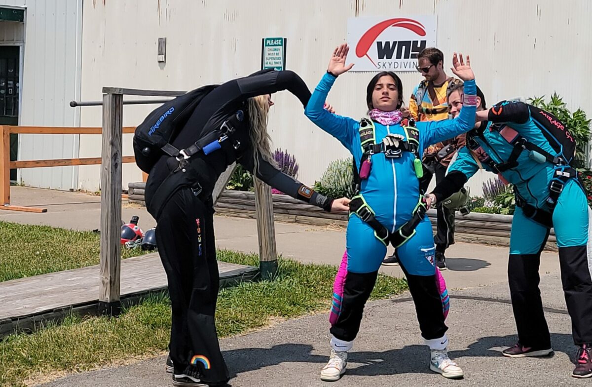 Skydiving instructor checking equipment on skydiver at WNY skydiving